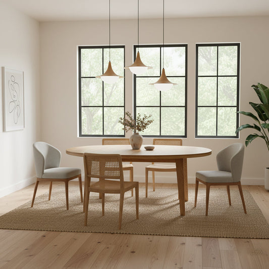 Dining room with wooden table and chairs in a well-lit room with large windows.