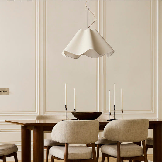 Dining room with wooden table, beige chairs, and a white pendant light.
