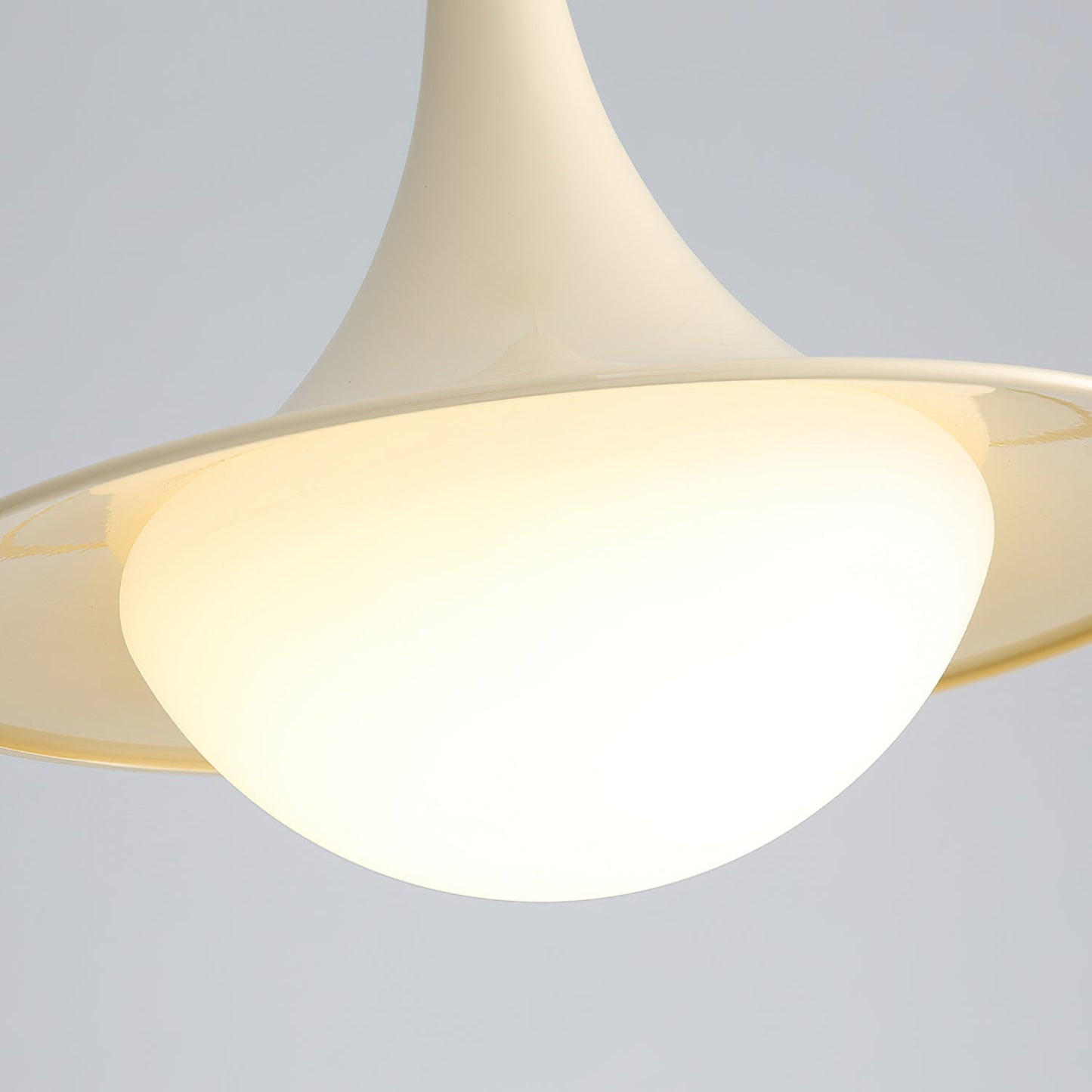 Close-up of a modern ceiling light fixture with a neutral background