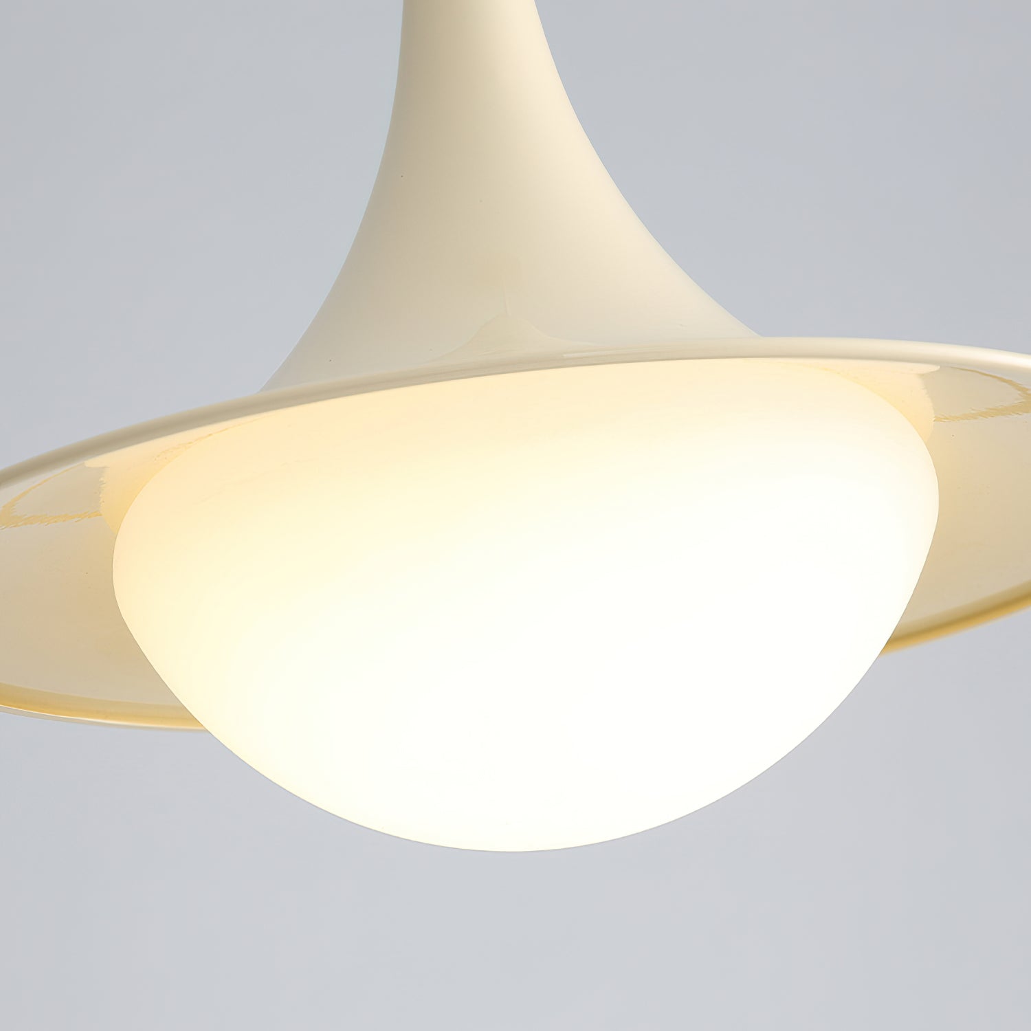 Close-up of a modern ceiling light fixture with a neutral background