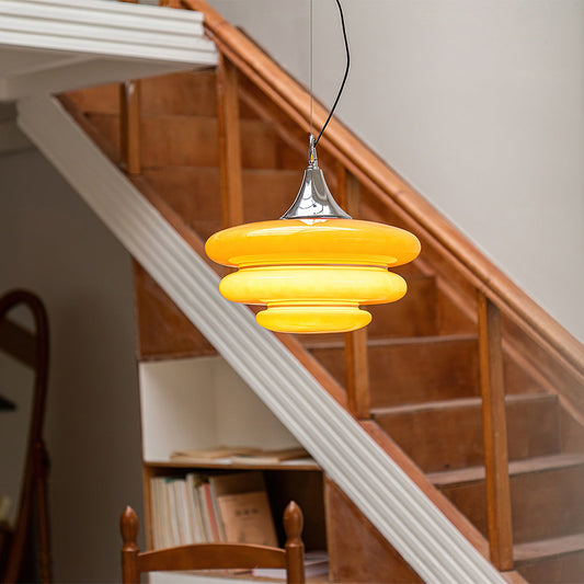 Yellow pendant light hanging above a staircase
