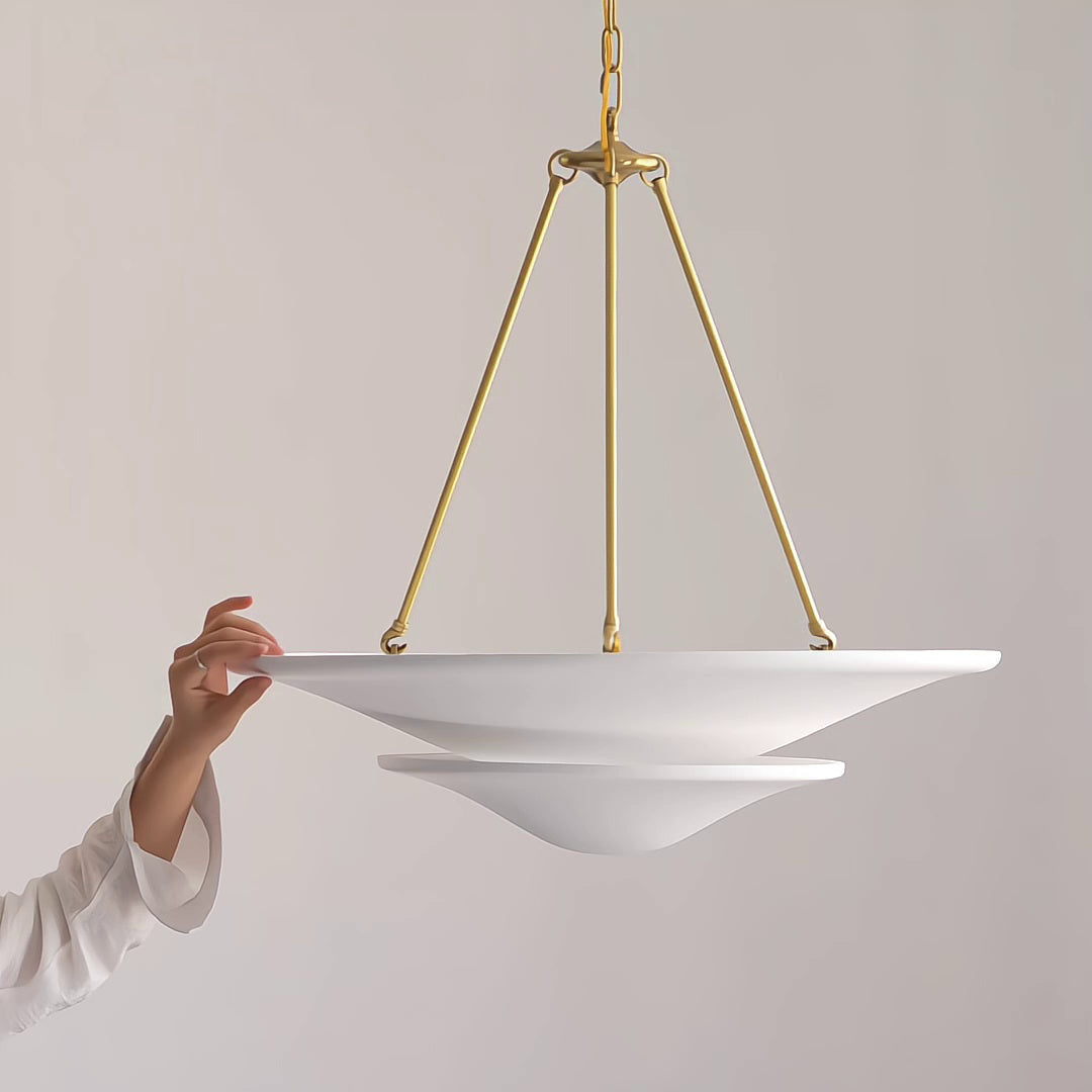 White pendant light with gold chain against a plain background