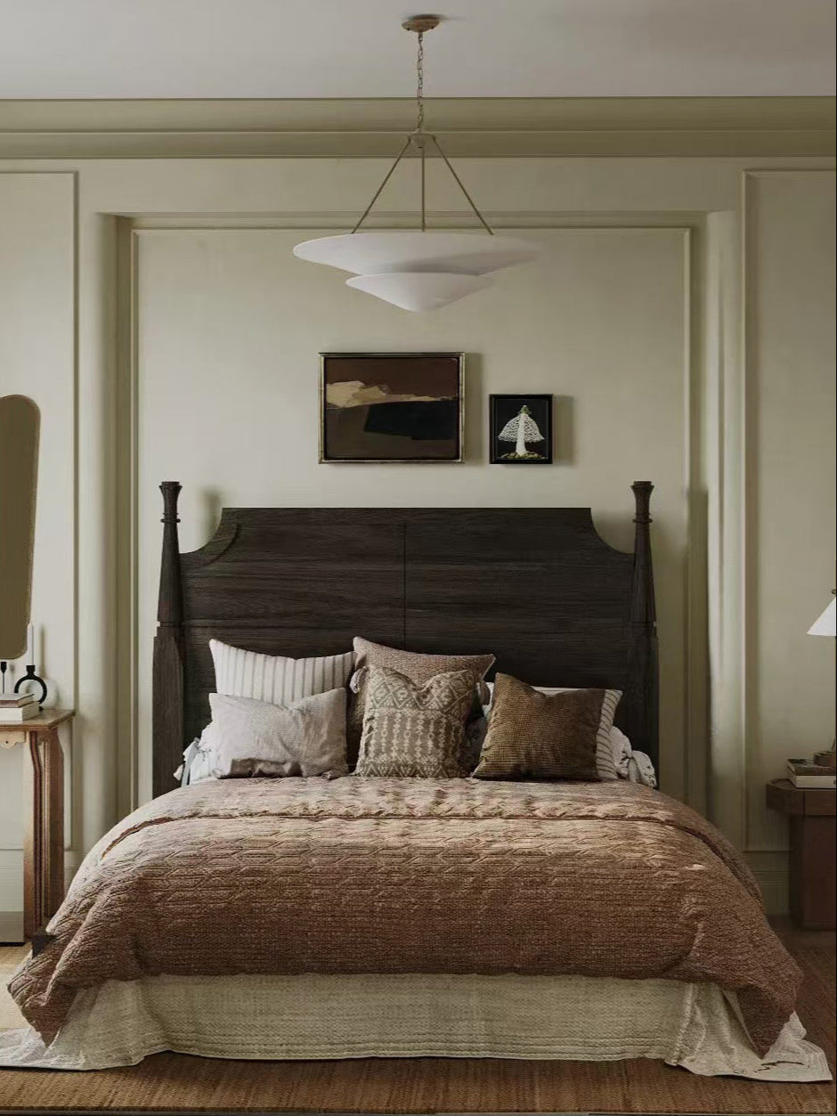 Bedroom with wooden headboard and brown bedding