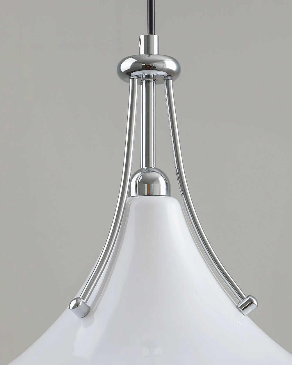 Close-up of a pendant light with white shade and chrome fixture on a neutral background